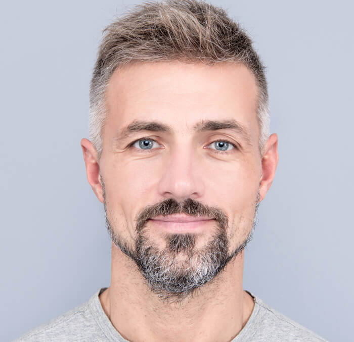 An elderly man with a beard and grey hair, reflecting a sense of maturity and knowledge