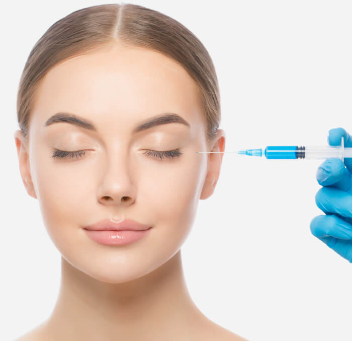 A woman receiving an injection on her face by a medical expert