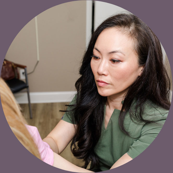 Dr. Christina H. Choe working with her patient